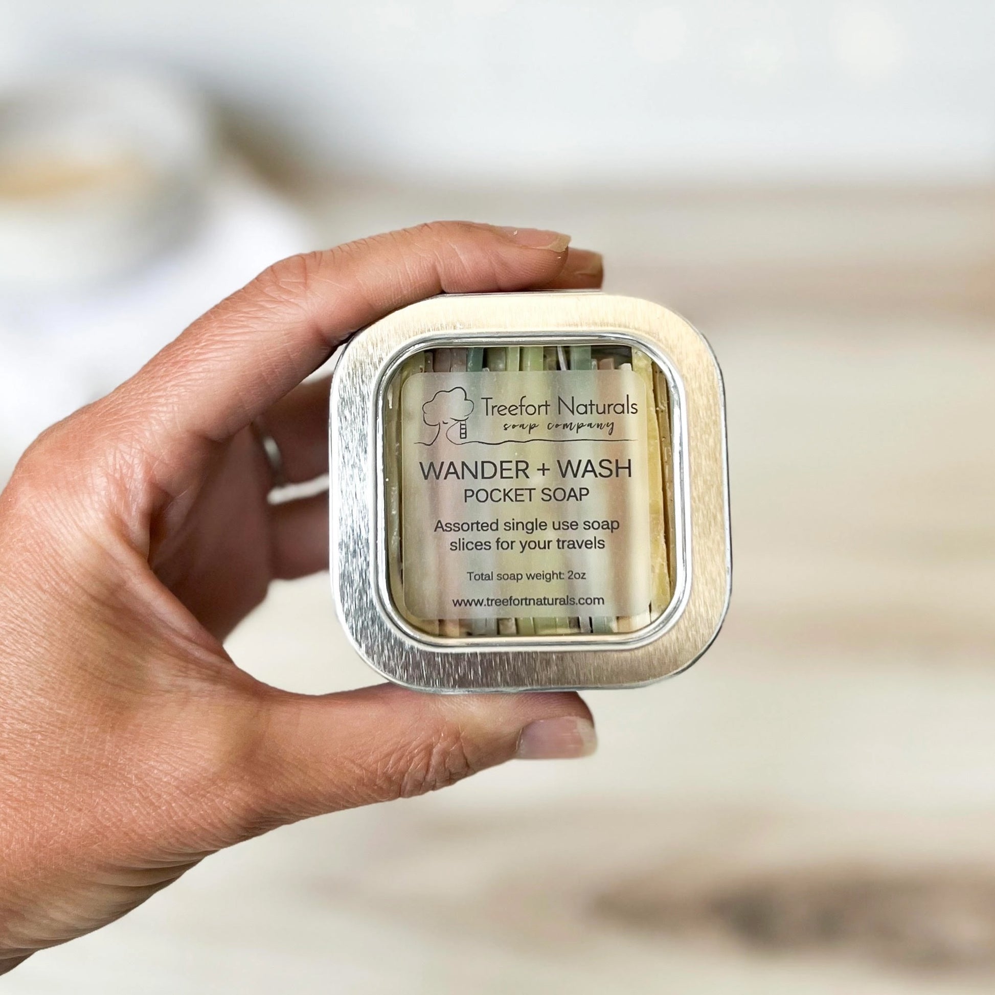 Hand shot holding Wander+wash Soap Slices Tin